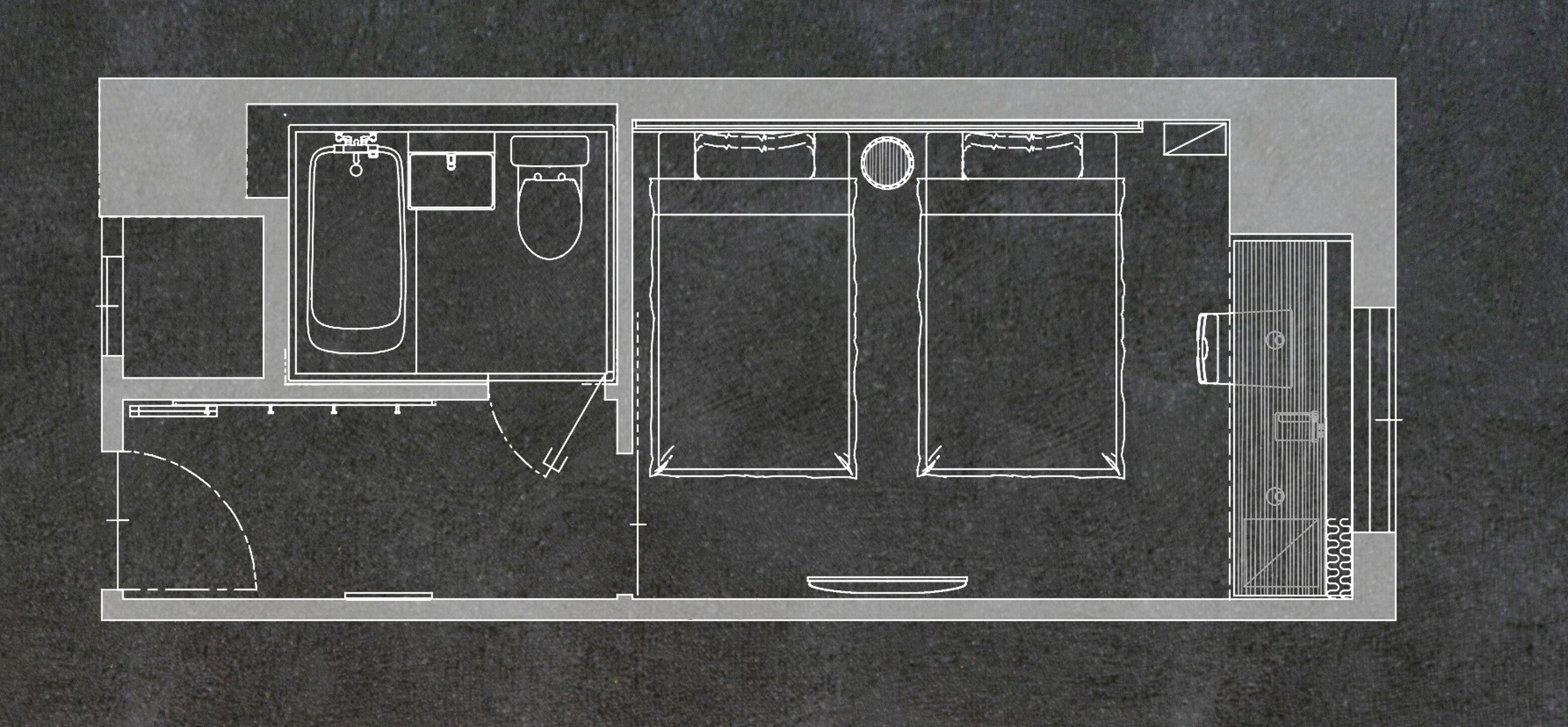 A floor plan of a hotel room with a bathroom, a kitchenette, and a seating area.
