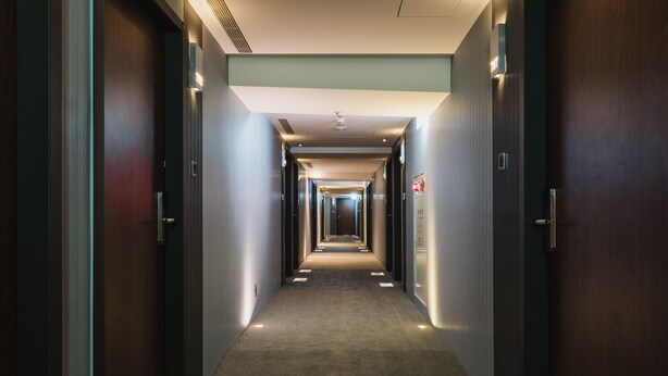 A long, narrow hallway with doors on both sides, leading to individual rooms. - Hej Taipei (Taipei)