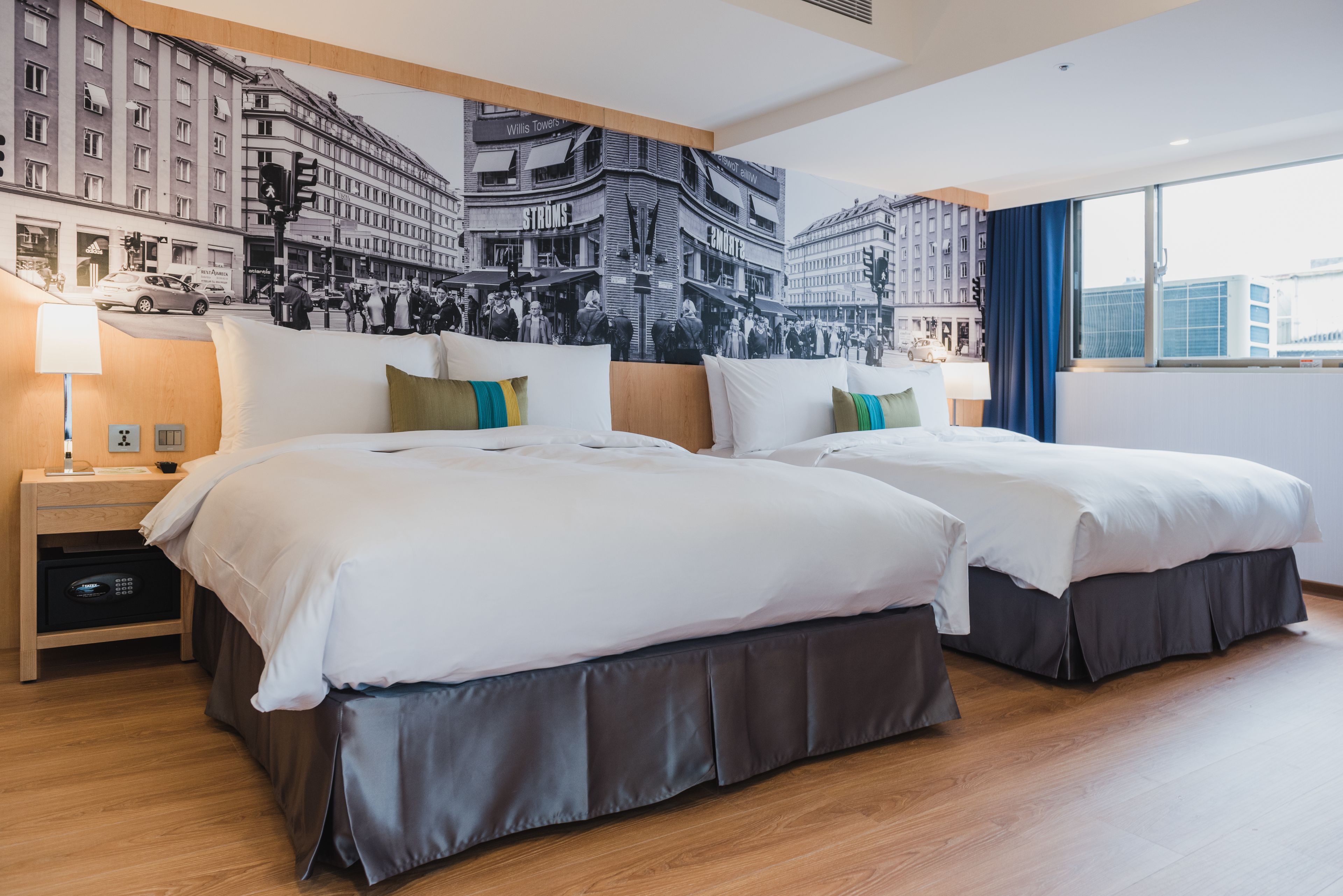 deluxe quadruple room, city view | down duvets, free minibar, in-room safe, desk