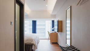 A hotel room with a bed, desk, chair, and large window. - Hej Taipei (Taipei)