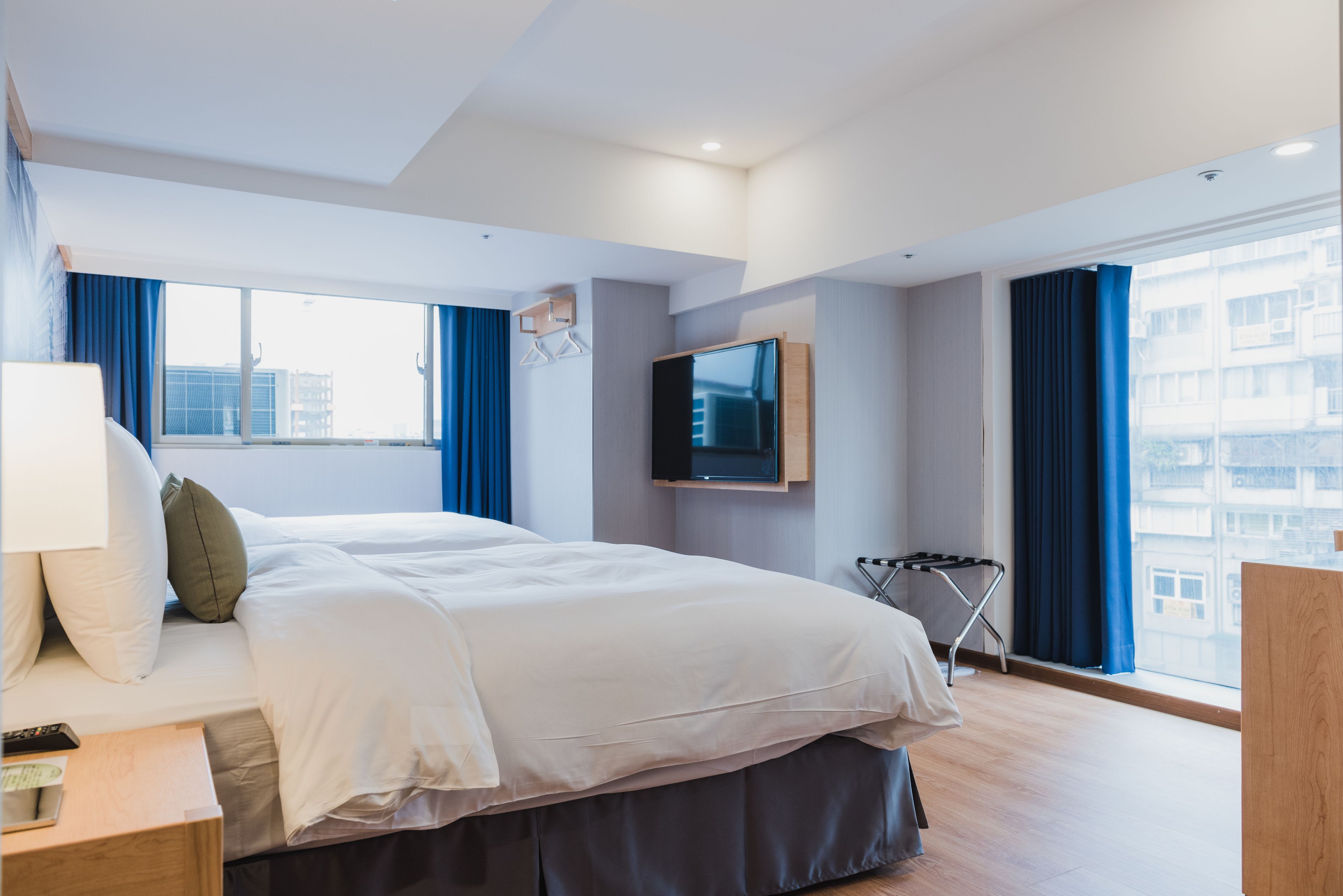 deluxe quadruple room, city view | down duvets, free minibar, in-room safe, desk