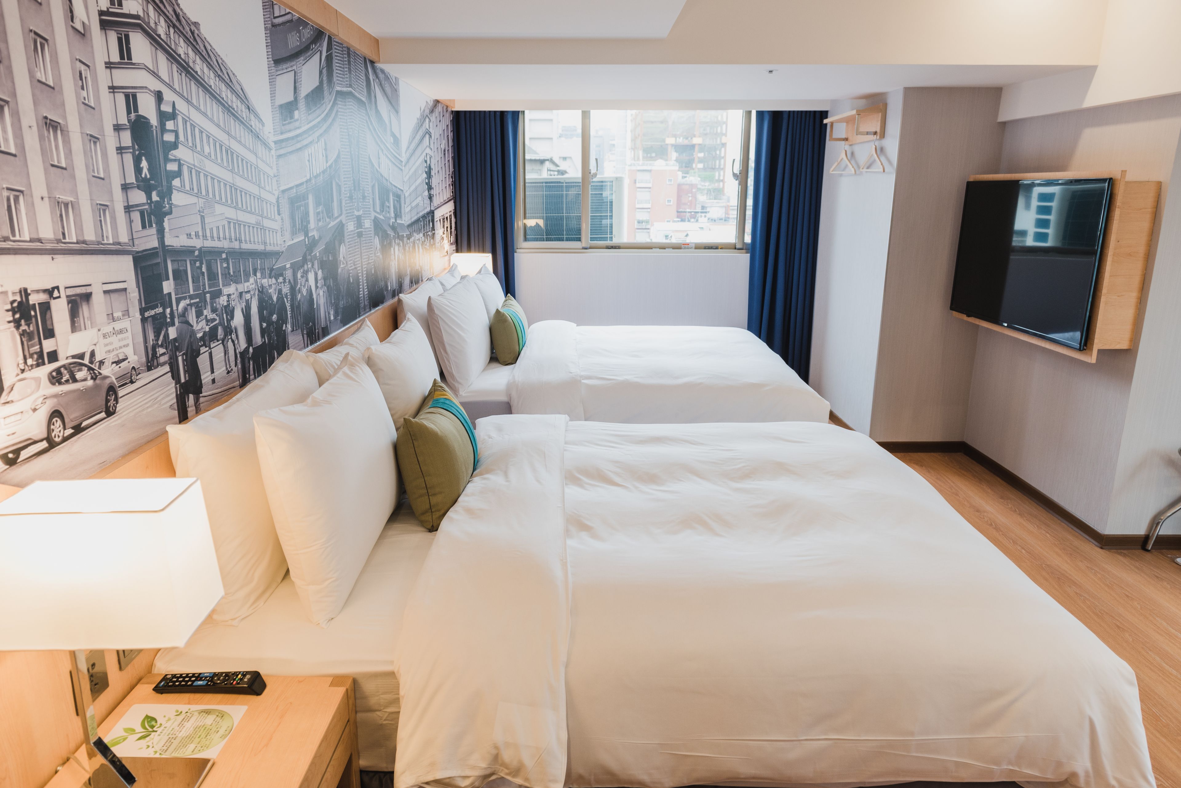 deluxe quadruple room, city view | down duvets, free minibar, in-room safe, desk