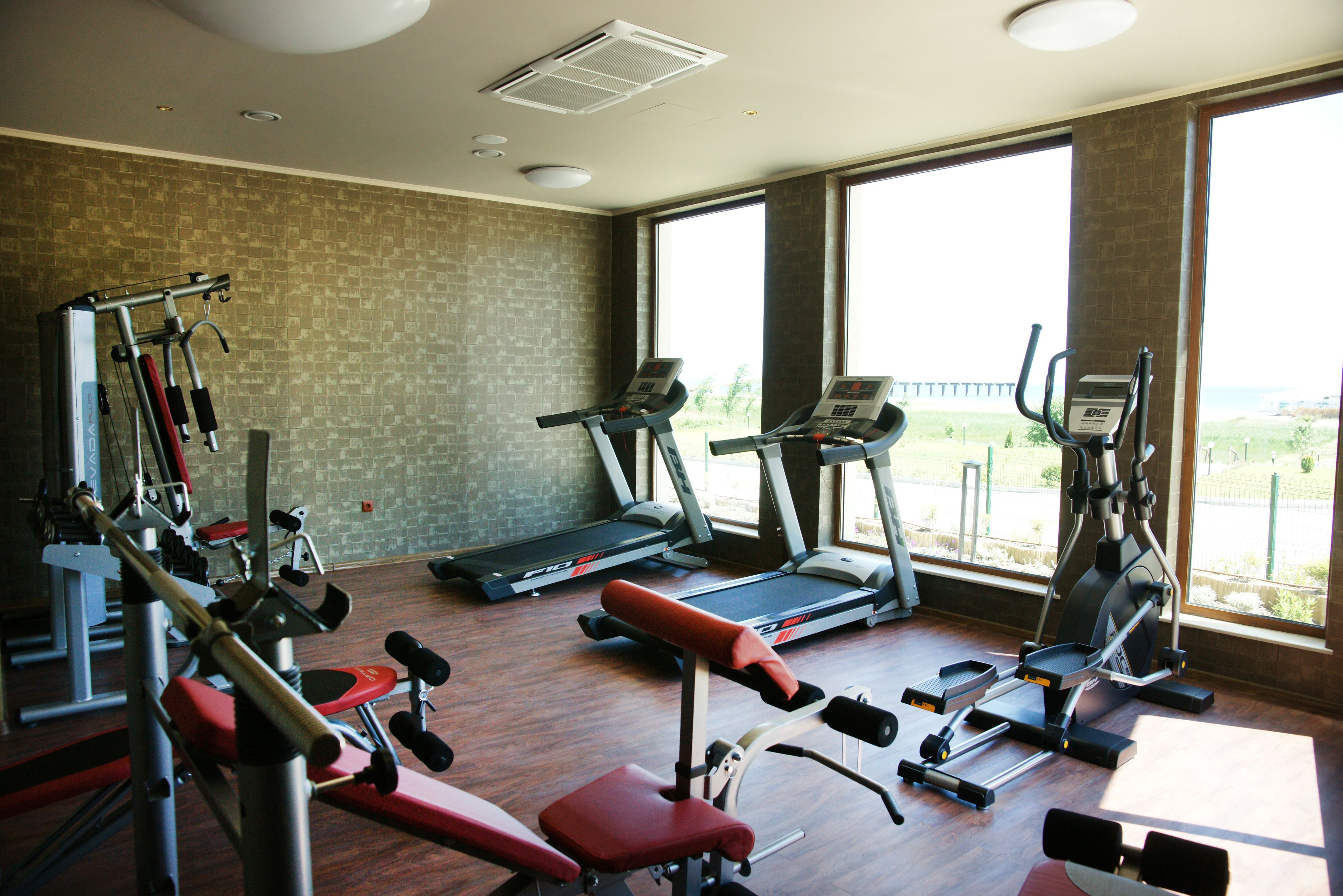 A gym with treadmills, stationary bikes, and weight machines.