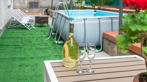 A bottle of Cantal Bosco wine, two glasses, and a pool in a backyard setting. - Villa Totti (Sant'Agnello)