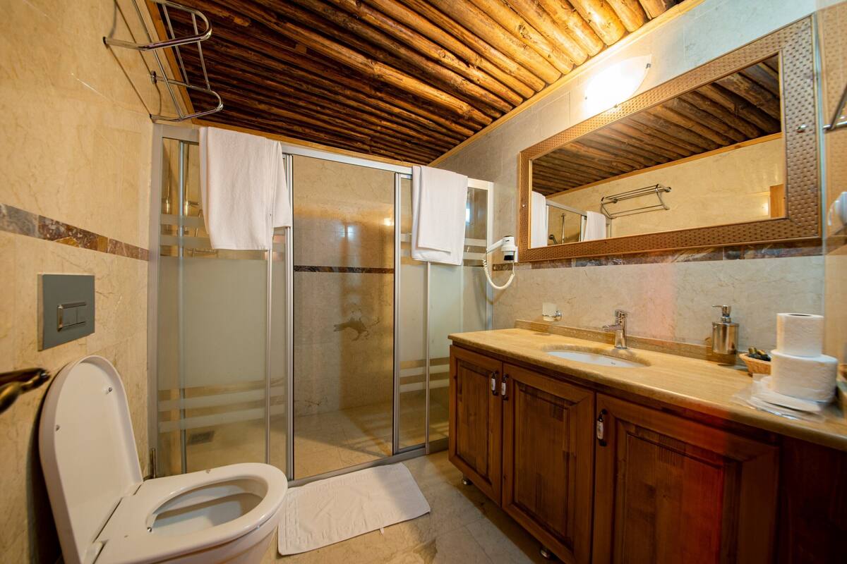 superior triple room | bathroom | shower, hair dryer, slippers, towels