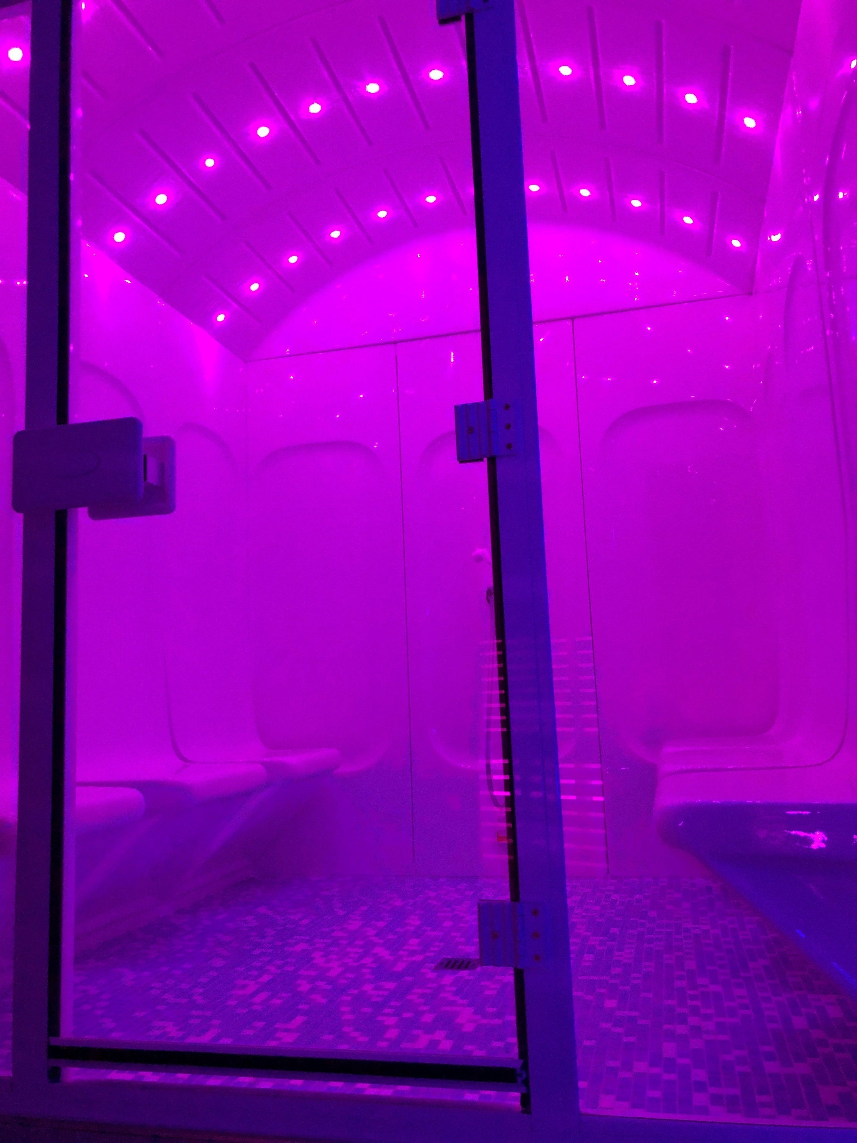 A room with a purple-lit ceiling and a patterned floor.