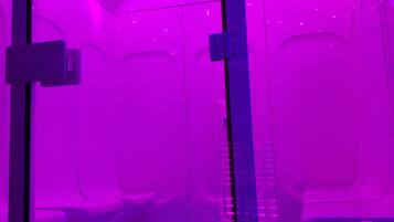 A room with a purple-lit ceiling and a patterned floor.