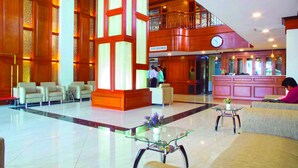 A spacious lobby with a high ceiling, a reception desk, and seating areas. - Gold Leaf Hotel (Mandalay)