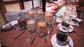 Ein Buffet mit verschiedenen Speisen, präsentiert in Glasbehältern und Schalen.
