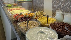 A buffet with various food items including fruits, cereals, and desserts. - Augusta SPA hotel (Hisarja)