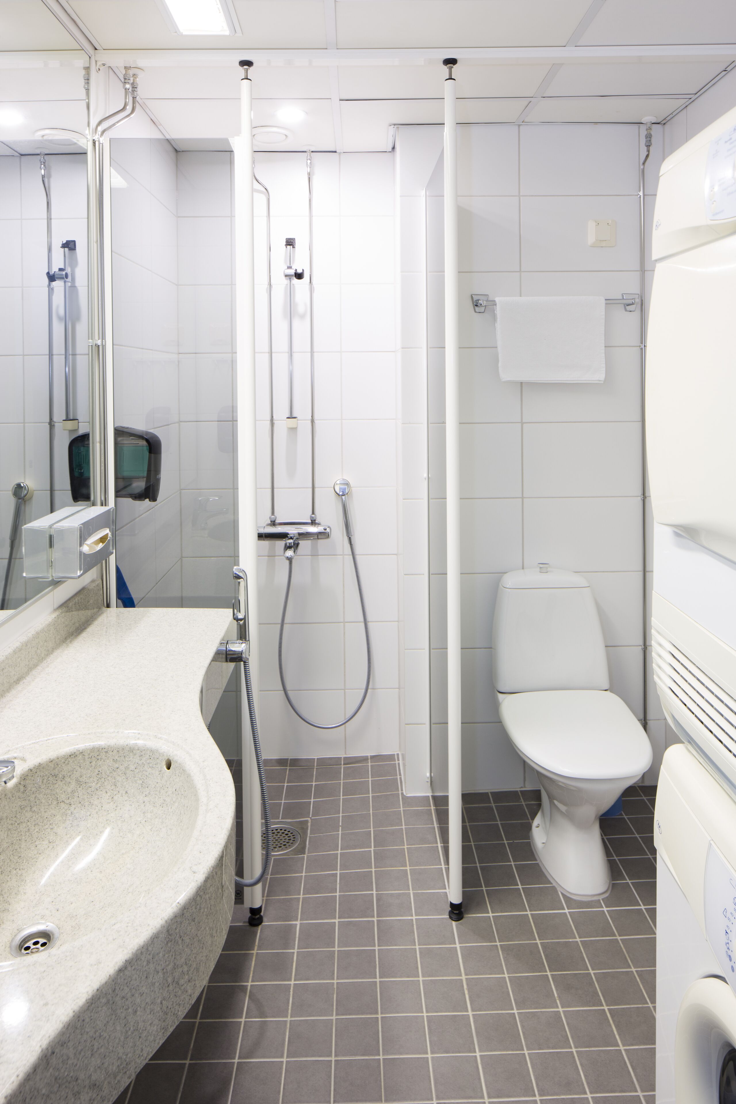A modern bathroom with a sink, toilet, and shower.