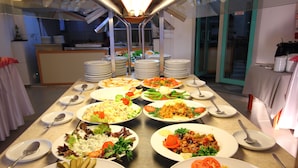 A buffet table with various dishes and utensils. - Rebin Beach Hotel (Fethiye)