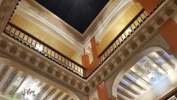A multi-level atrium with ornate railings and intricate ceiling designs. - Riad Dar Nakhla (Marrakech)