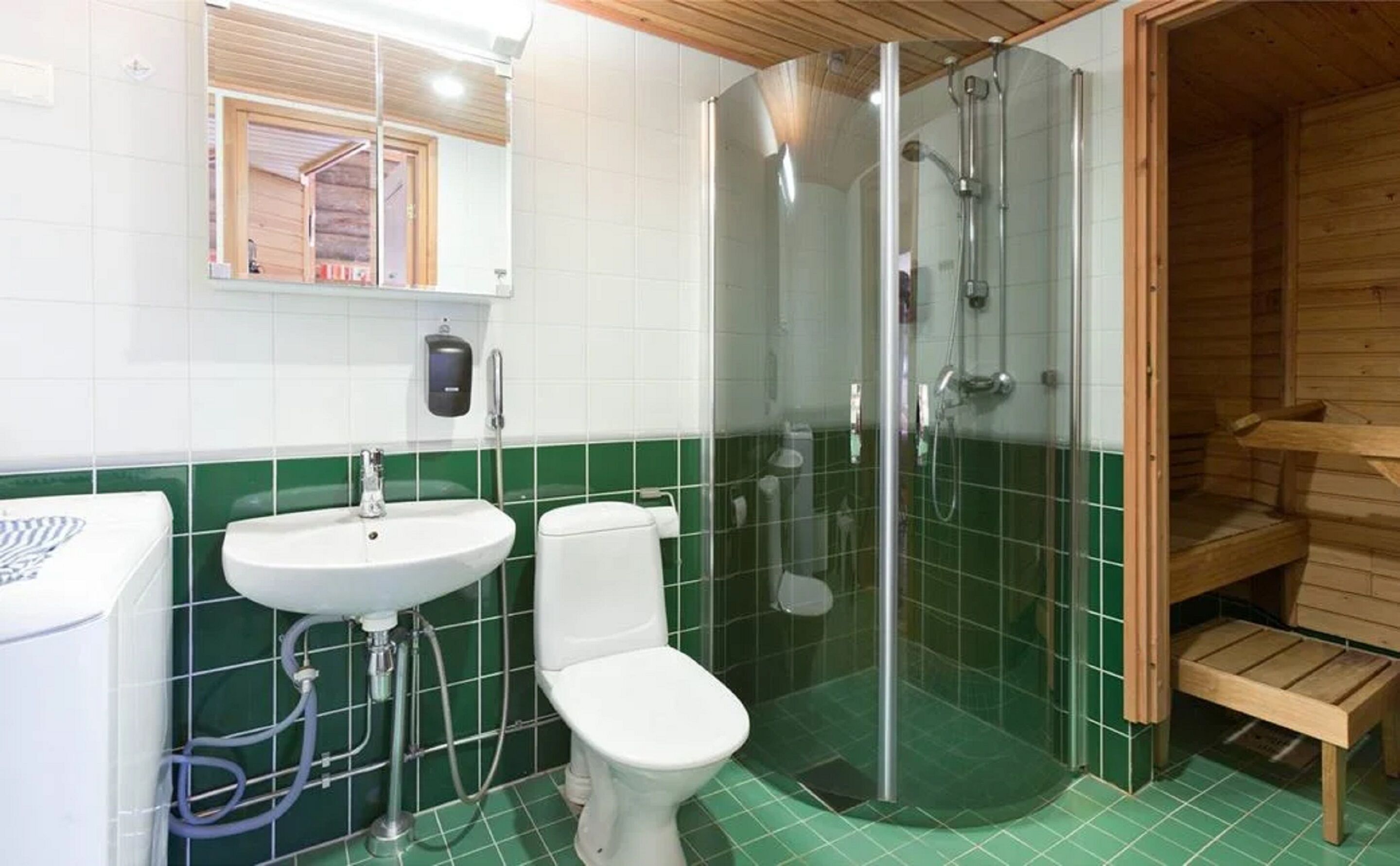 A bathroom with a sink, toilet, and glass-enclosed shower.