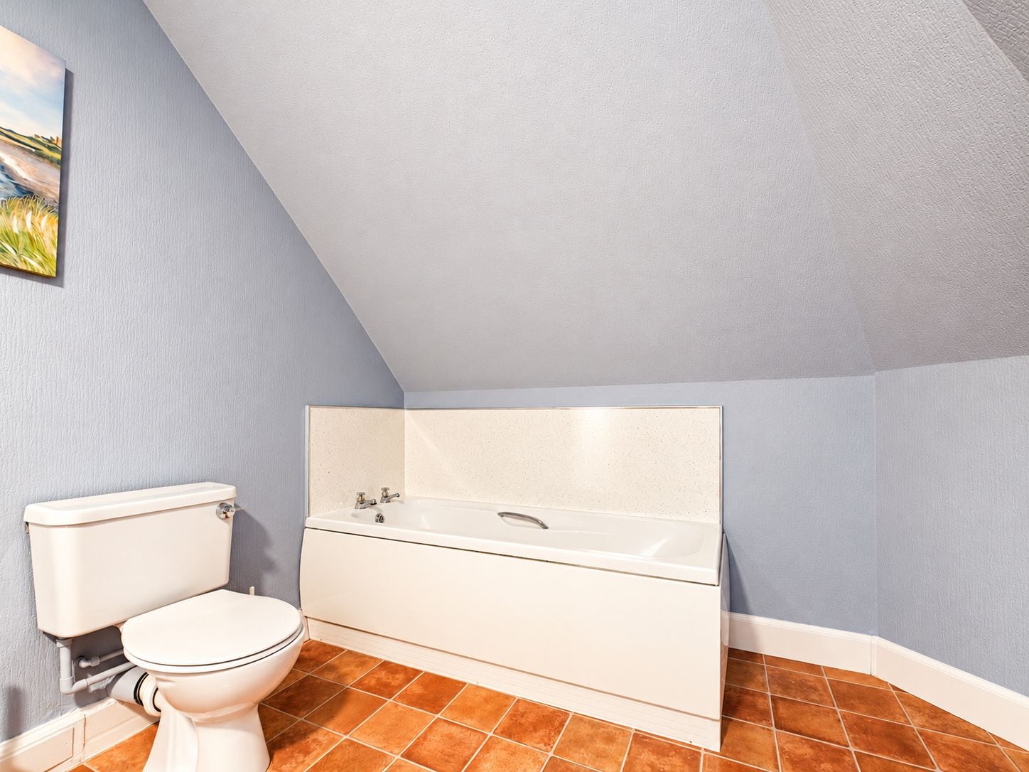 A bathroom with a toilet, a bathtub, and a sink.