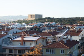 A residential area with multiple houses, some with balconies, and a large building in the background. - Ilci Residence Hotel (Ankara)