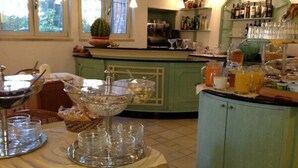 A breakfast buffet setup with various food items and beverages. - Hotel Miramare (Forte dei Marmi)
