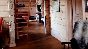 A log cabin interior with a wooden staircase, a wooden floor, and a door leading to another room. - Blazerbu - Cabin for 8 persons - Hol (Hol)