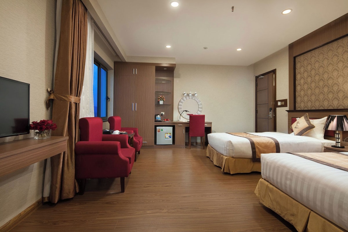Une chambre d’hôtel équipée d’un lit, d’un bureau, d’une chaise et d’un téléviseur.