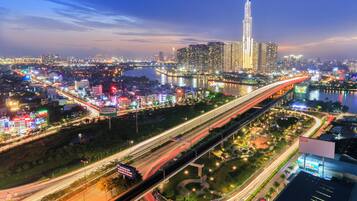 A cityscape with a prominent skyscraper, interconnected highways, and a river.