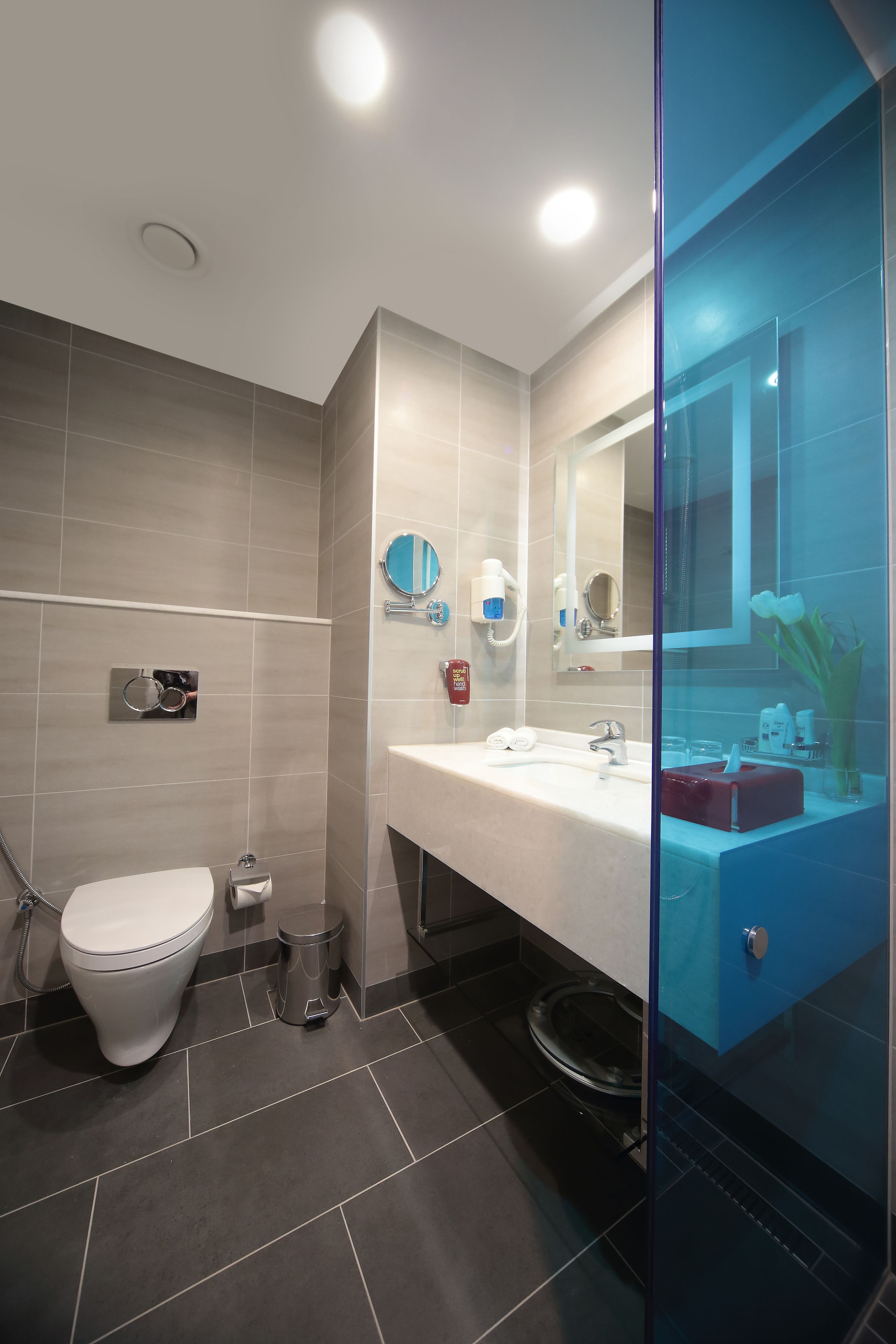 A modern bathroom with a toilet, sink, and shower area.