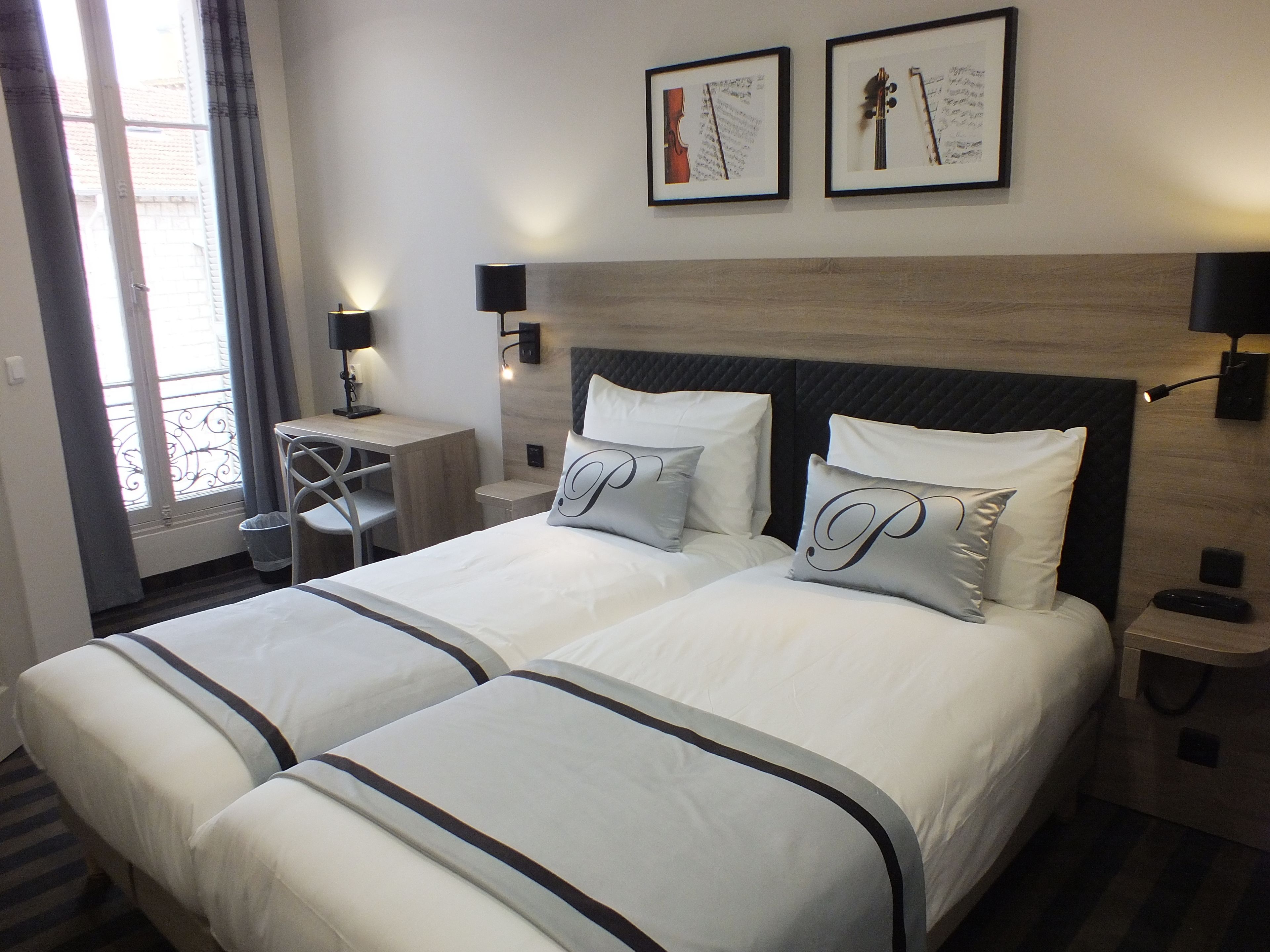 Twin kamer | Een minibar, een kluis op de kamer, een bureau, geluiddichte muren