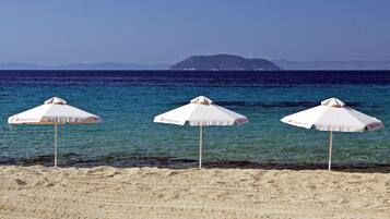 On the beach, sun-loungers, beach umbrellas