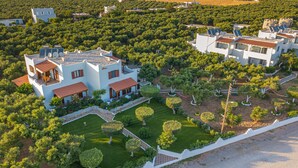 A residential area with modern houses, well-maintained gardens, and a clear view of the surrounding landscape. - Paradisos (Sfakia)