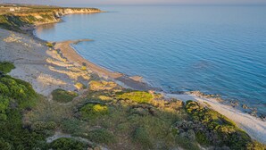 A coastal landscape with a beach, cliffs, and vegetation. - Paradisos (Sfakia)