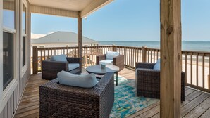 A covered outdoor deck with wicker furniture and a view of the ocean. - Family Tides | Pool, on west end. Nightly Sept stays (Dauphin Island)