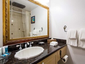 A bathroom with a large mirror, a sink, a towel rack, and a toilet paper holder. - Suite Living w/Island Touches! Updated Kitchen, Lanai, WiFi–Kamaole Sands 1206 (KIHEI)