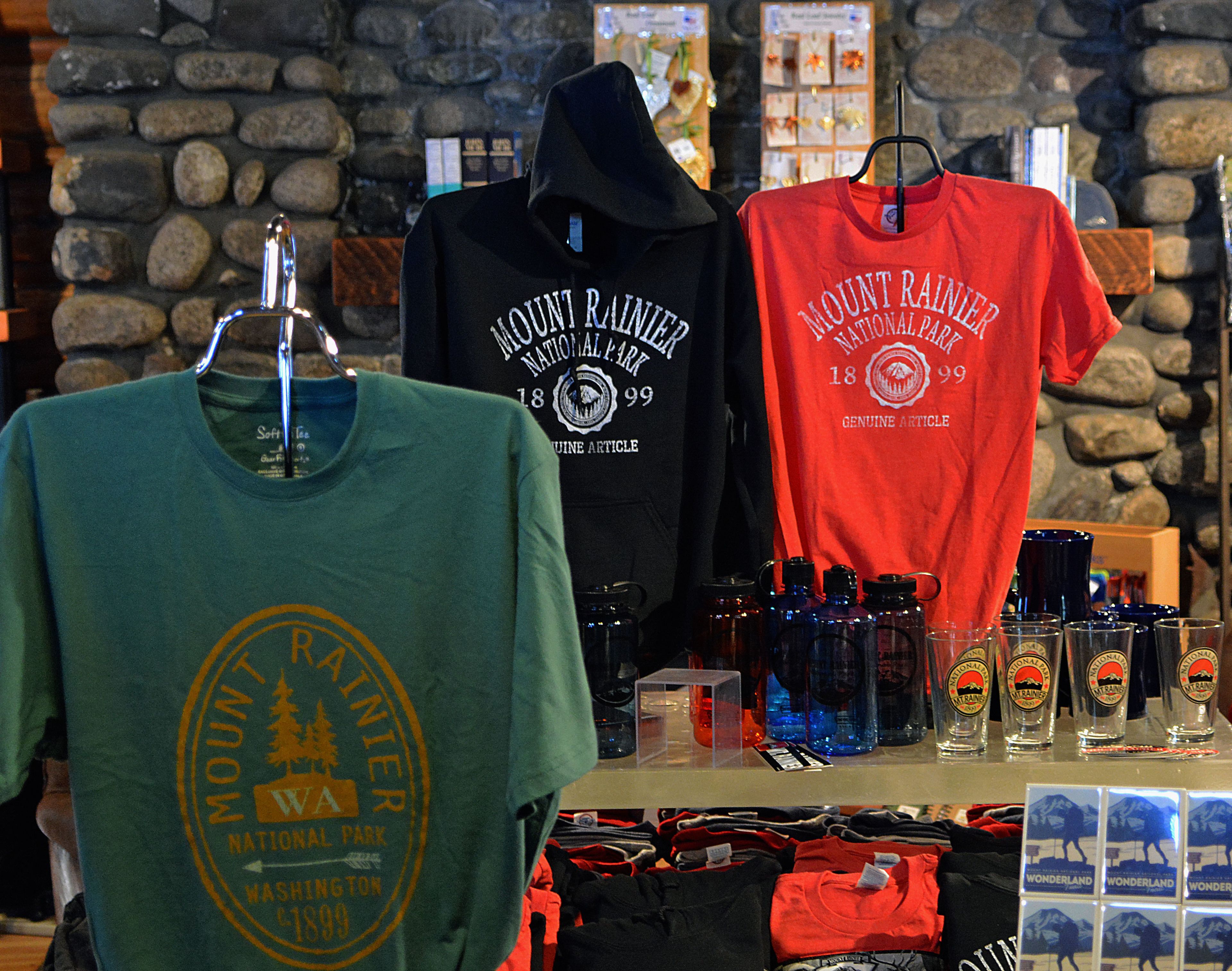 A display of Mount Rainier National Park t-shirts and water bottles.