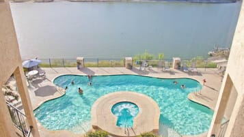 Relax by the pool surrounded by a serene lake or river view.