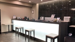 A reception area with a counter, computers, and a scale.