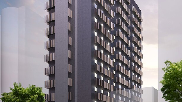 A modern high-rise building with a prominent vertical entrance and a series of balconies.