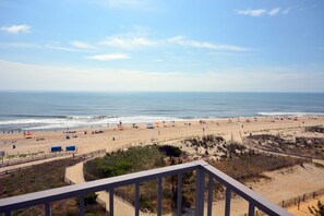 On the beach - Colorful, spacious 2 bedroom oceanfront condo with WiFi, an outdoor pool, and a great ocean view located midtown and just steps to the beach! (Ocean City)