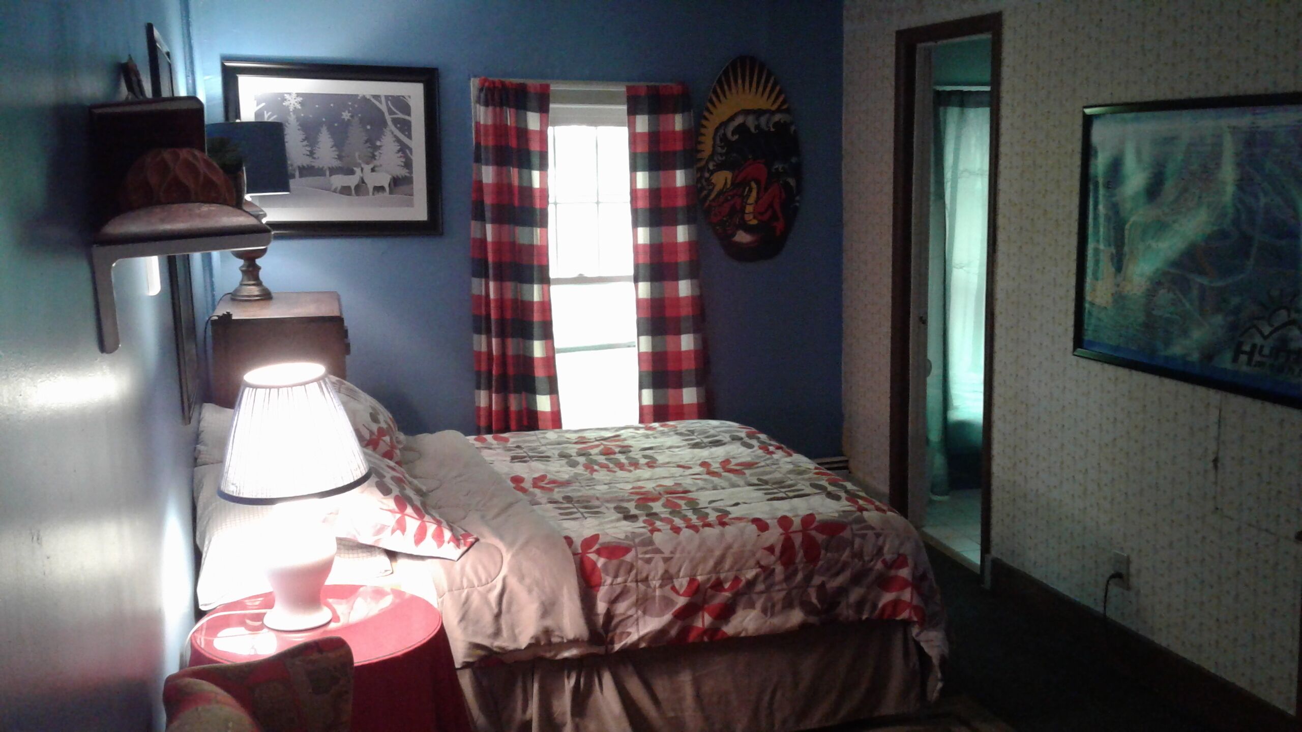 This cozy bedroom also has a full bed and a private bathroom.