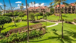 A resort with multiple buildings, palm trees, and well-maintained lawns. - Island Energy in Suite w/Lanai, Washer/Dryer, WiFi, Kitchen–Kamaole Sands 7302 (KIHEI)