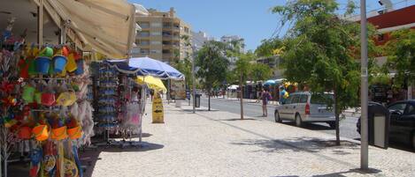 A street with shops, including a beachwear store and a surf shop.
