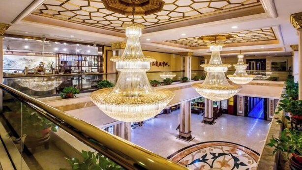 A hotel lobby with multiple chandeliers, a glass railing, and a decorative ceiling. - Mountain Villa Hotel (Chengde)