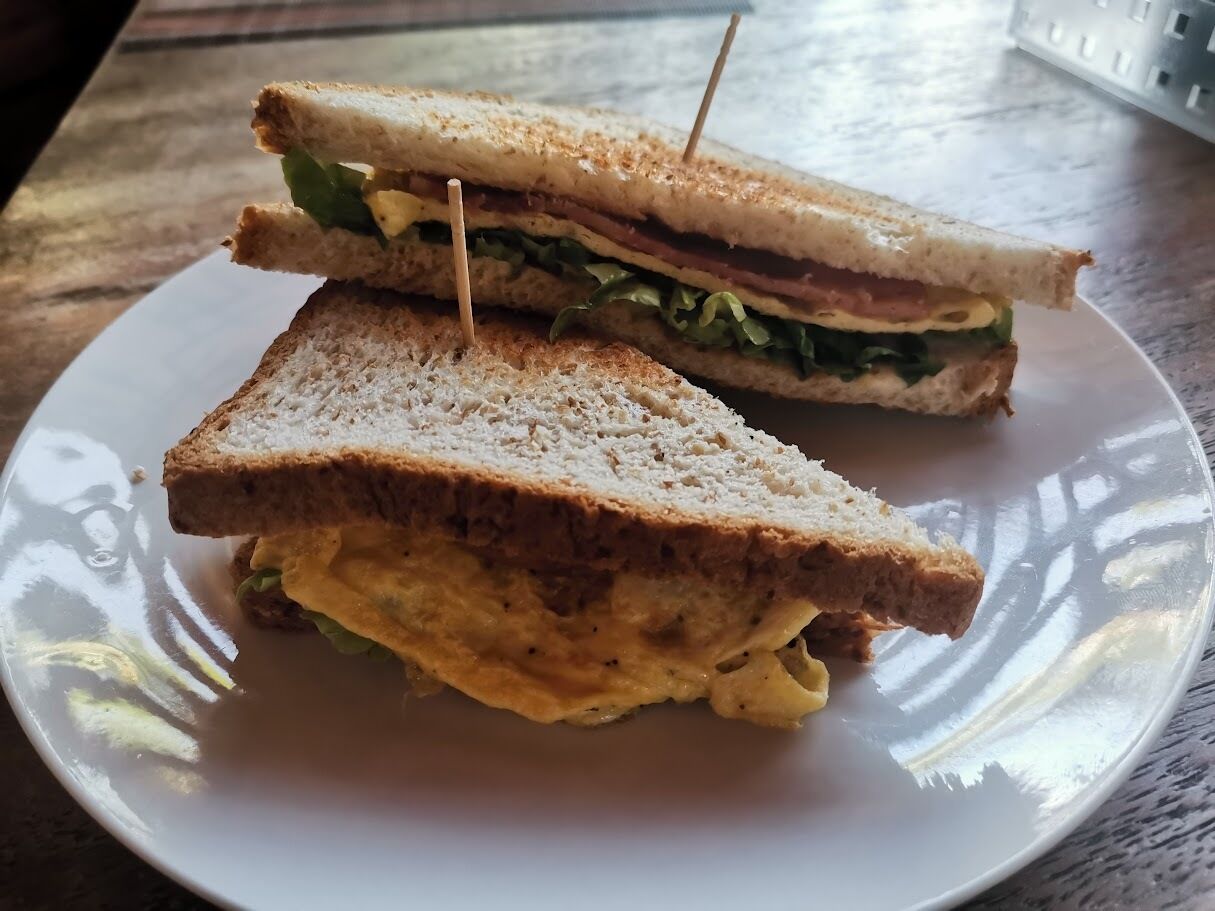 A sandwich on a white plate.