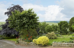 Gardens of one acre including a paved patio area with garden furniture