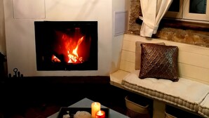 A cozy room with a fireplace, a clock, and a chandelier. - Cute vacation house surrounded by green area (Buzet)