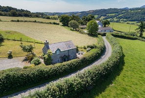 Ty Ucha'r Fforrd with enclosed garden, part of which is on a slope with a level sitting area in front of the cottage commanding the view and others behind the cottage - Ty Ucha’r Ffordd, Bodnant Estate, Colwyn Bay, Conwy, Wales (Colwyn Bay)