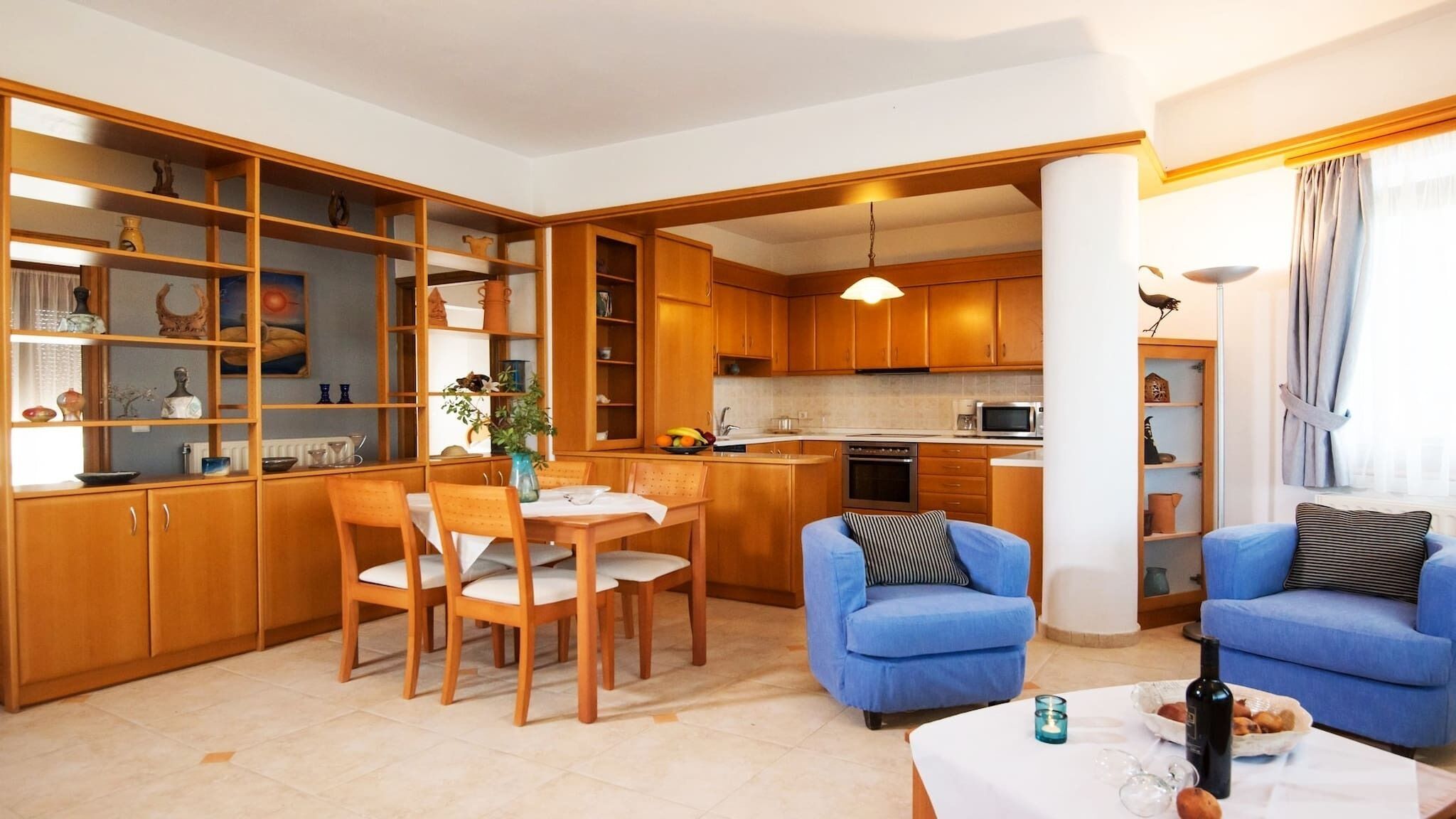 A compact living space with a dining area, kitchen, and seating area.