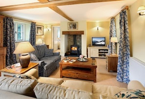 Ground floor:  Sitting room with beamed fireplace and wood burning stove with doors to the garden area