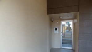 A hallway with a door leading to a staircase. - Weekly Harbor View Mansion Ginowan (Ginowan)