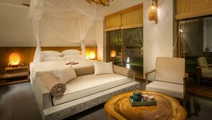 A bedroom with a canopy bed, a sofa, a wooden coffee table, and a chair. - Alba Wellness Resort By Fusion (Hue)