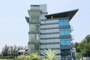 A modern building with a unique architectural design, featuring a mix of glass and concrete materials.