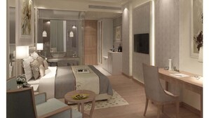 A modern hotel room with a large bed, a desk, a chair, and a TV.